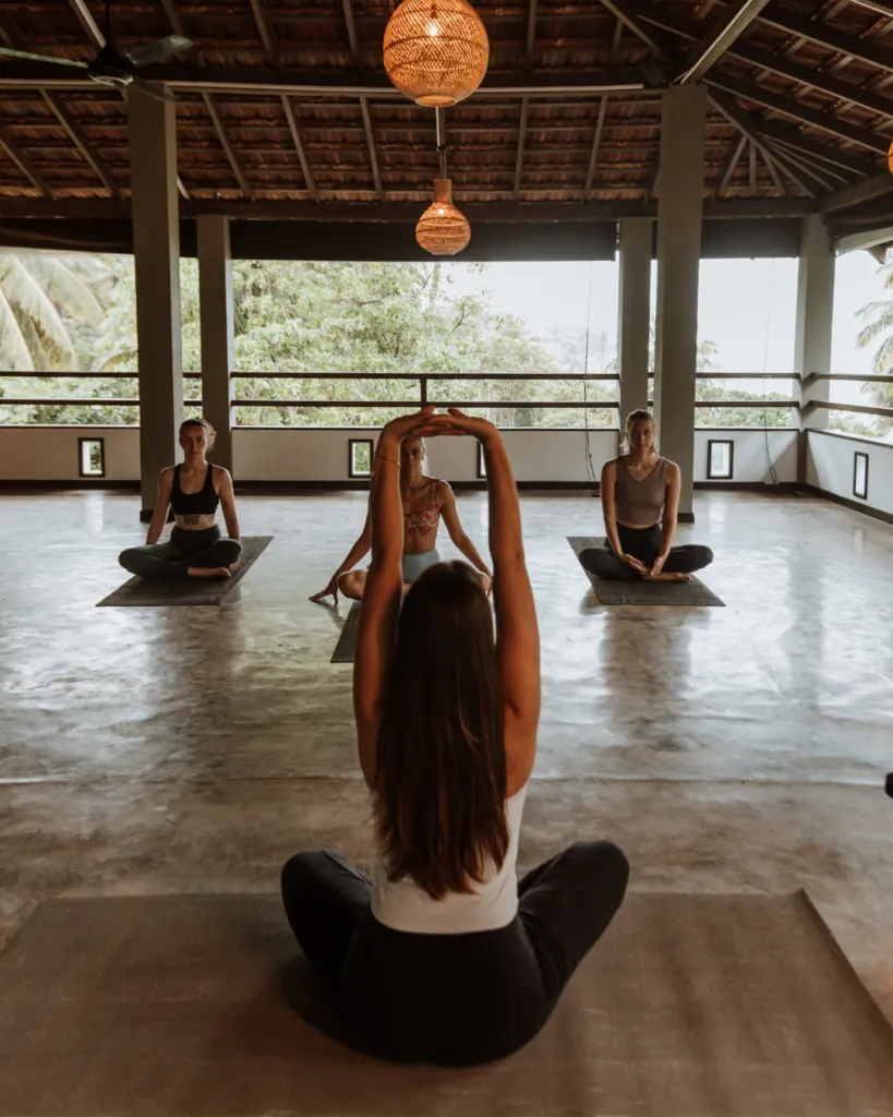 Guest meditating in the open-air yoga shala at Jasper House Hiriketiya