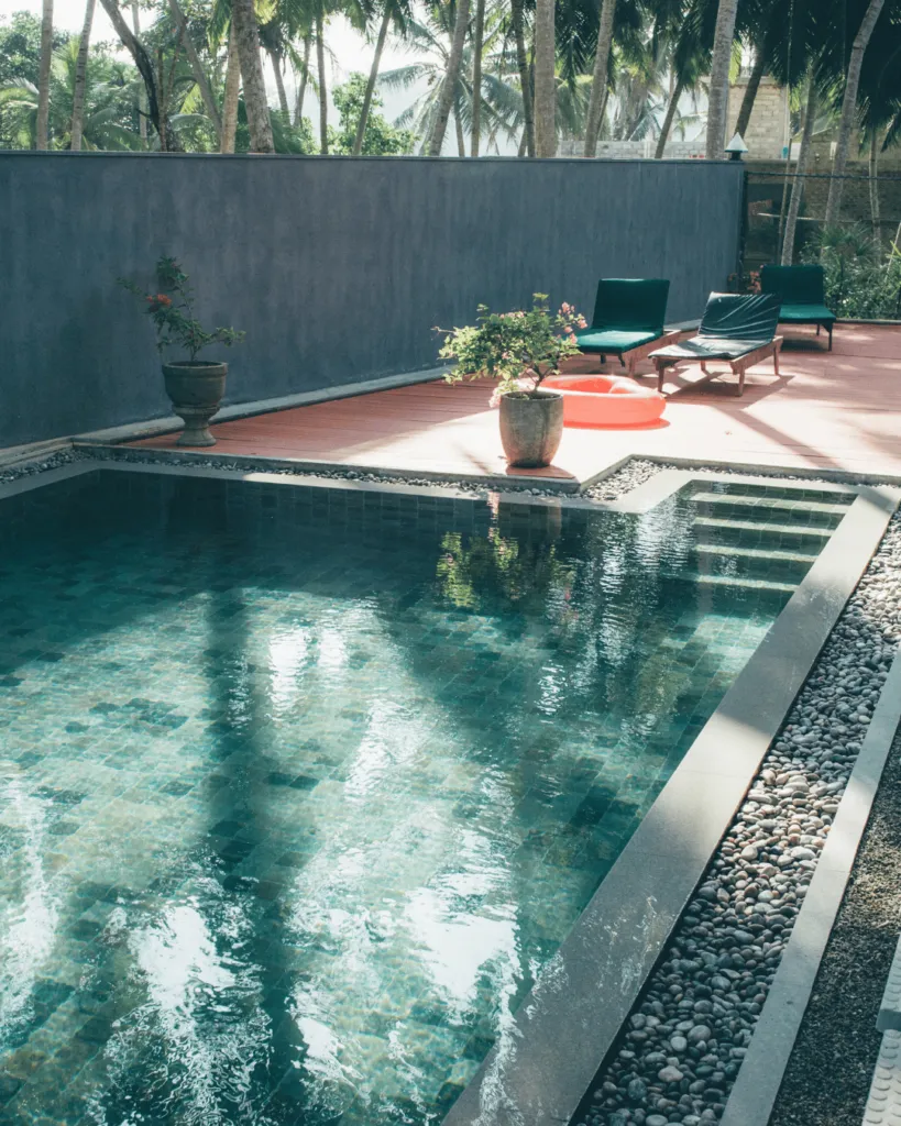 Swimming pool framed by tropical greenery at Jasper House Hiriketiya