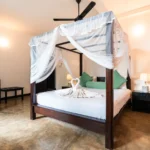 Swan towel art on the four-poster bed in the Deluxe Standard Room