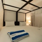 Deluxe Pool View Room bed with striped pool towels
