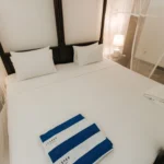 Fresh linen and pool towels in the Deluxe Pool View Room