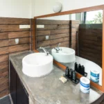 Stone vanity with toiletries in the Deluxe Standard Room bathroom