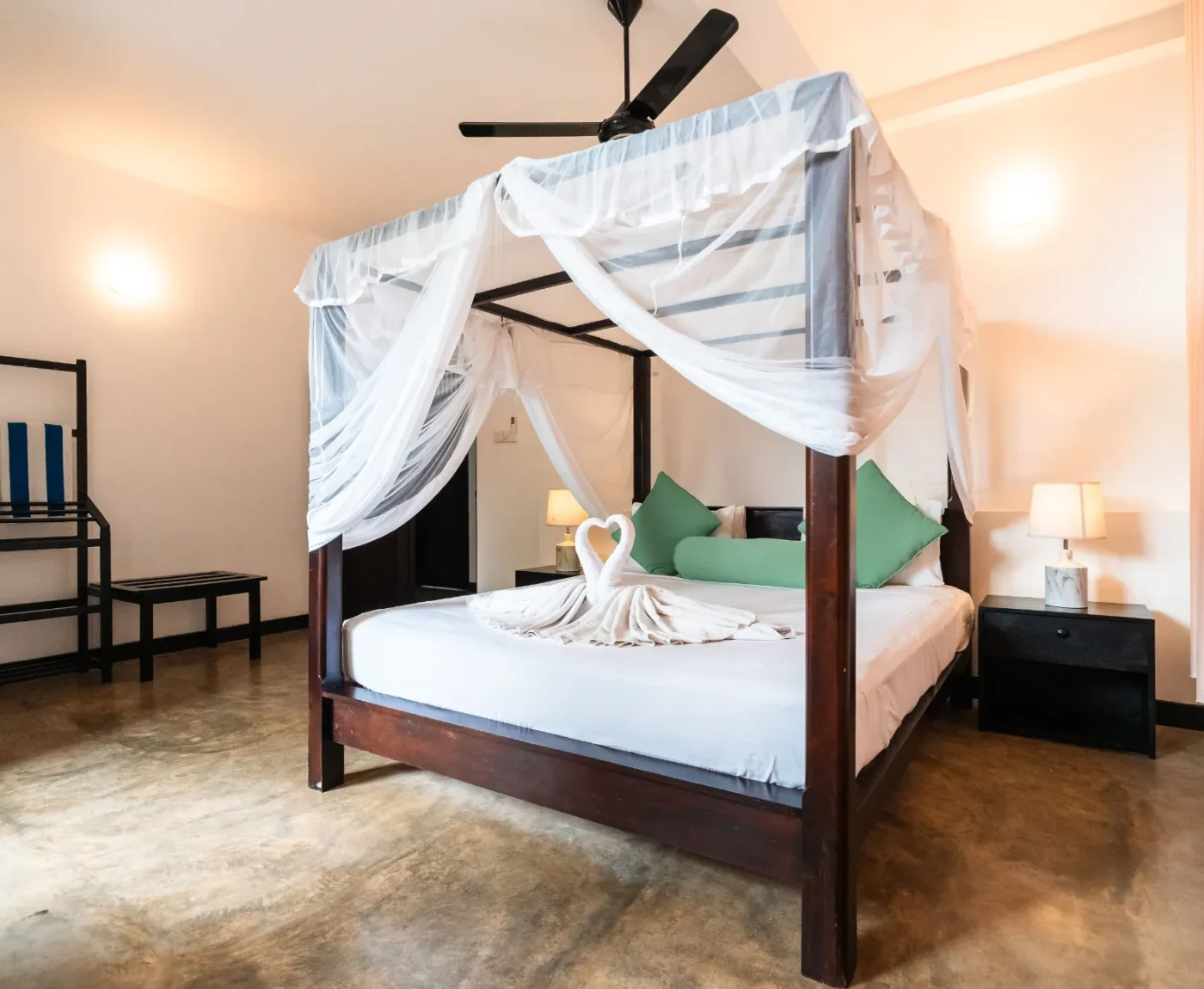 Swan towel art on the four-poster bed in the Deluxe Standard Room